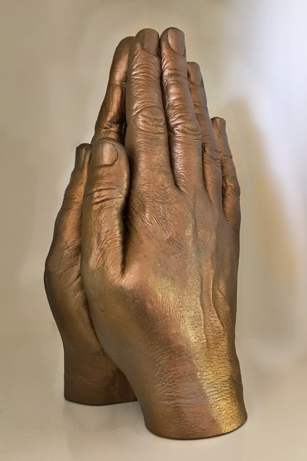 Praying hands statue