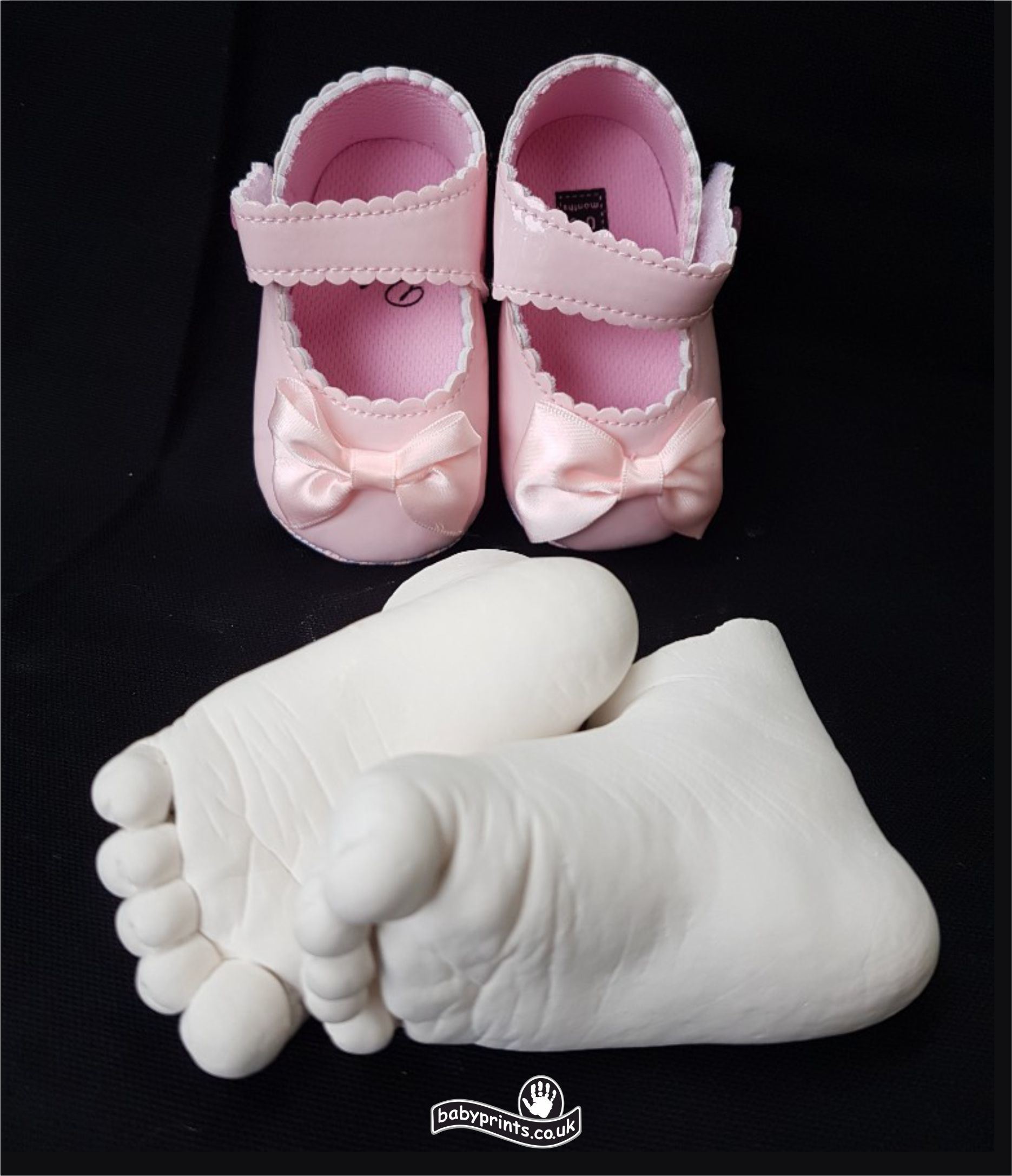 First ballet shoes and feet statues